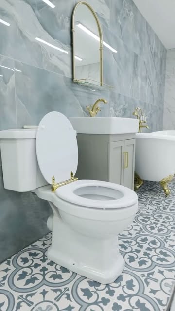 Classic bathroom with patterned floor tiles and gold accents